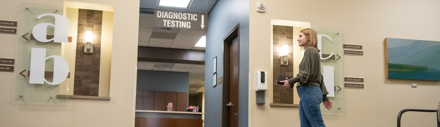 a woman walking into the diagnostic testing office spokane eye clinic